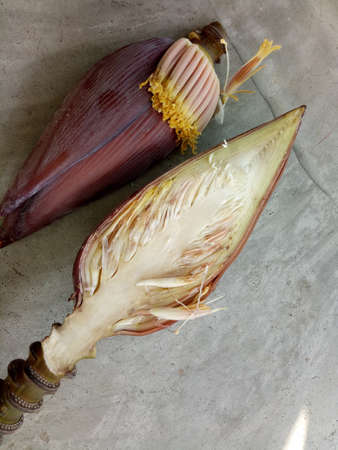 A cut banana flower close-up. Asia. Exotic cooking. Healthy lifestyle. Cement background. Copy space.の写真素材