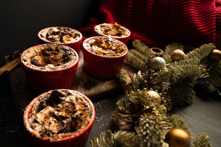 Christmas composition. Christmas cupcakes in red plates. Traditional holiday dessert. Copy space. Dark background.の写真素材