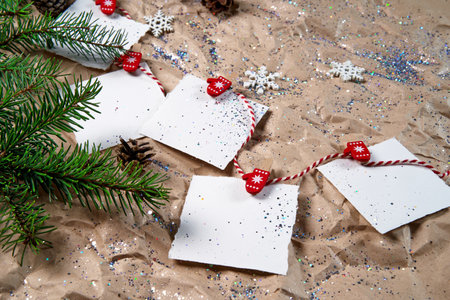 White notebooks on a New Year 's background . Happy New Year and Merry Christmas. New Year's goals or promises with colorful decorations on the background of crumpled kraft paper with Christmas tree branches. From above , flat lay.の写真素材