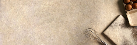 Bakery products. Dessert ingredients and utensils on a flour table background. Web banner, top view. Copy space. egg, flour, whisk, cutting board.の写真素材