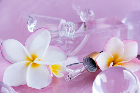 Decorative elements showcase aloe serum and centella in a serene spa setting with Frangipani flowers.の写真素材