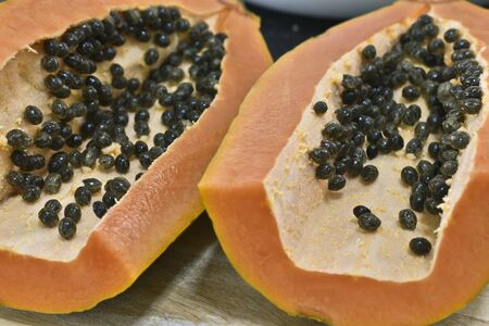 Close up half of papaya fruits with seedsの写真素材