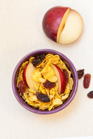 Corn flakes with slices of plum and raisins