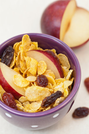 Corn flakes with slices of plum and raisins