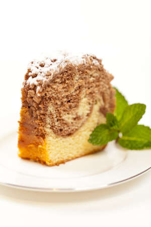 A slice of freshly baked ring cake with icing sugarの写真素材