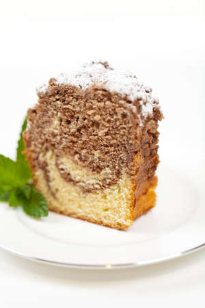 A slice of freshly baked ring cake with icing sugarの写真素材