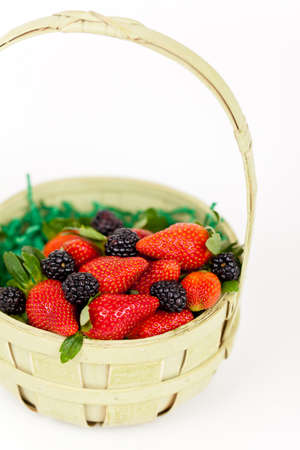 Fresh strawberries and blackberry in basketの写真素材