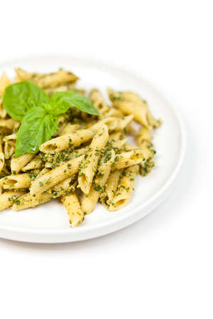 Penne pasta with pesto sauce, fresh basil and nutsの写真素材