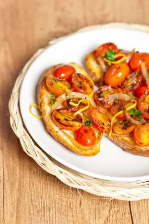 Italian Bruschetta with baked cherry tomatoes and onionの写真素材