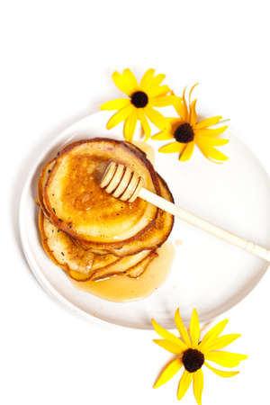 A stack of pancakes with honey の写真素材