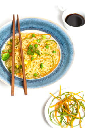 Instant noodles with carrots, peas and green onion の写真素材