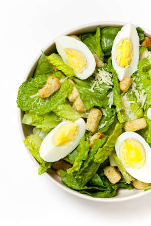 Caesar salad with eggs, lettuce, croutons and parmesanの写真素材