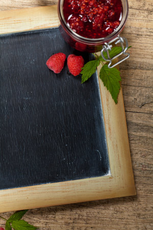 Fresh Raspberries jam with chalkboard  Selective focus