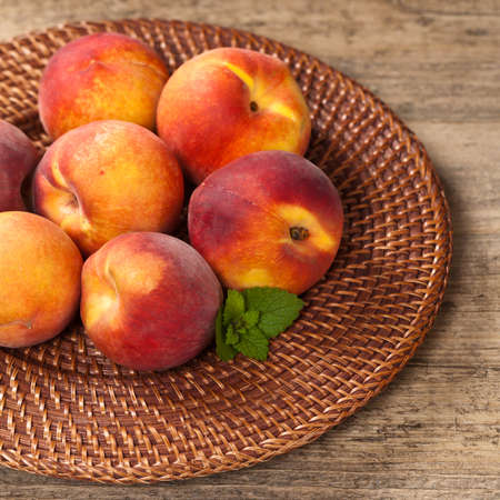 Fresh peaches on wood background. Selective focus.の写真素材