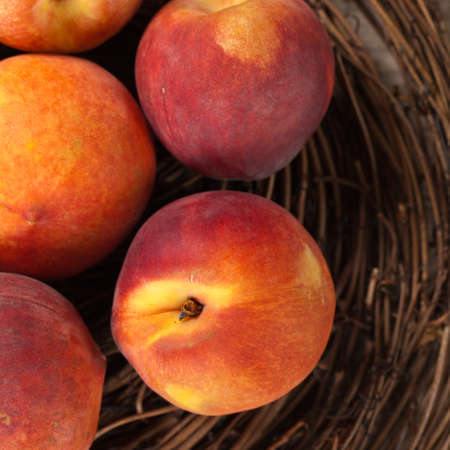 Fresh peaches on wood background. Selective focus.の写真素材
