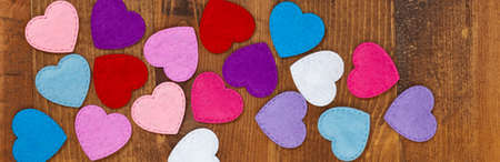Valentines day background with toy hearts over wooden table. Selective focus.の写真素材