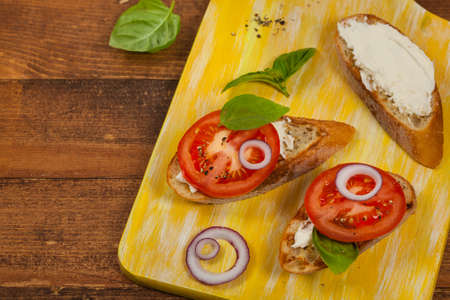 Bruschetta Sandwich with Tomato, Cream Cheese and Basil. Selective focus.の写真素材