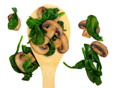 Sauteed Spinach and Mushrooms isolated on white. Selective focus.の写真素材