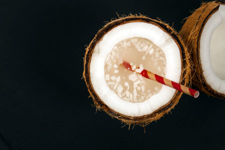 Coconut Water with Pulp on Black Background. Selective focus.