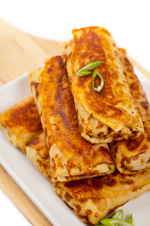 Russian Stuffed Pancakes Blintzes with Meat Isolated on White. Selective focus.