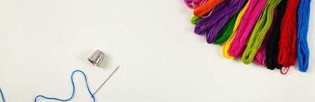 Embroidery Floss Background on a white cloth. Concept for sewing and embroidery. Selective focus.の写真素材