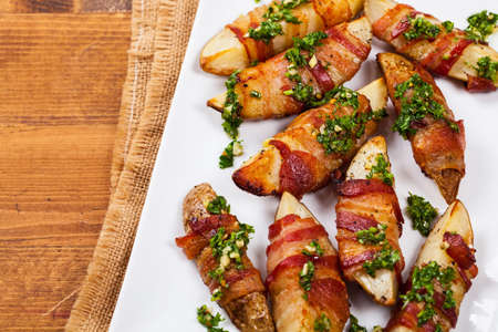 Bacon Wrapped Potatoes with Parsley Garlic Pesto Sauce. Selective focus.の写真素材