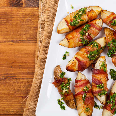 Bacon Wrapped Potatoes with Parsley Garlic Pesto Sauce. Selective focus.の写真素材