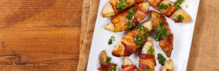 Bacon Wrapped Potatoes with Parsley Garlic Pesto Sauce. Selective focus.の写真素材