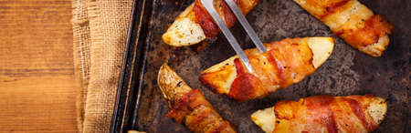 Bacon Wrapped Potatoes Wedges. Selective focus.の写真素材