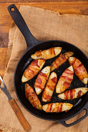 Bacon Wrapped Potatoes Wedges. Selective focus.の写真素材