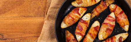 Bacon Wrapped Potatoes Wedges. Selective focus.の写真素材