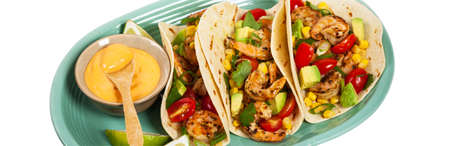 Shrimp Tacos with Corn and Avocado Salsa Isolated on White background. Selective focus.の写真素材