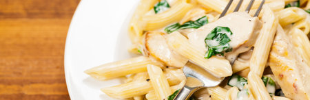 Chicken Alfredo Pasta with Spinach. Selective focus.