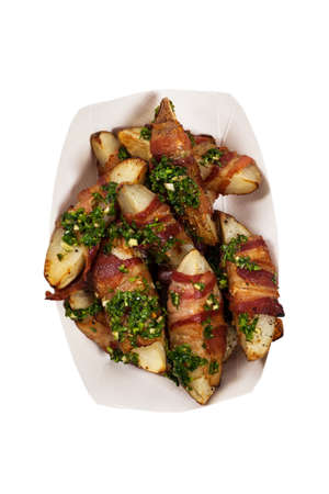 Bacon Wrapped Potatoes Wedges with Parsley Garlic Pesto Sauce Isolated on White background. Selective focus.の写真素材