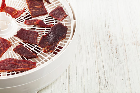 Homemade Beef Jerky with a dehydrator. Selective focus.