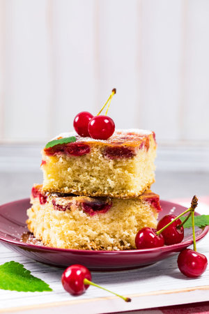 Breakfast Cherry Cake with Powdered Sugar. Selective focus.