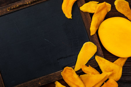 Dried Mango Fruit. Education Chalkboard Background Concept with Copy Space. Selective focus.