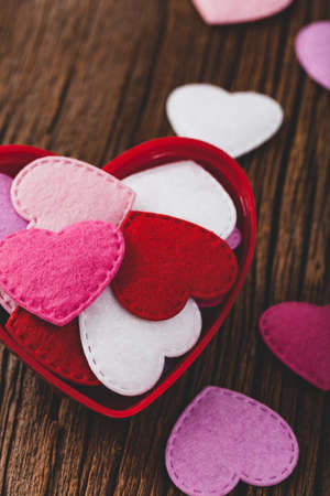 Valentines day background with toy hearts over wooden table. Selective focus.の写真素材