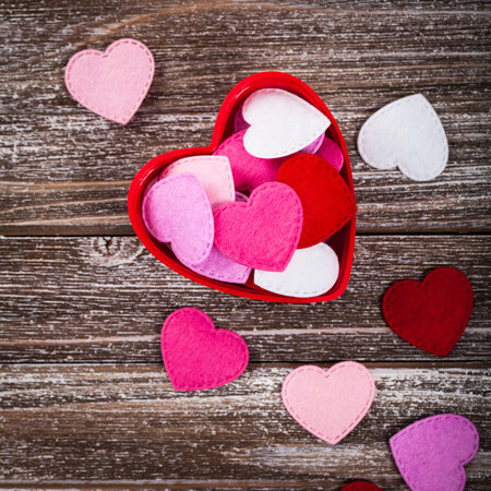 Valentines Day Card Background with Fabric Hearts over Wooden Background. Selective focus.の写真素材