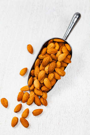 Scoop Full of Organic Raw Almonds Nuts. Selective focus.の写真素材