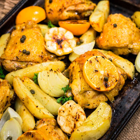 Chicken Thighs Roasted with Meyer Lemon and Potatoes. Selective focus.の写真素材
