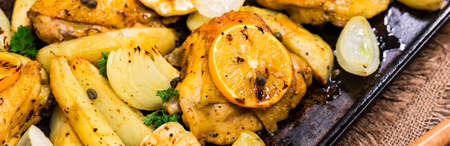 Roasted Chicken with Potatoes and Meyer Lemon. Selective focus.の写真素材