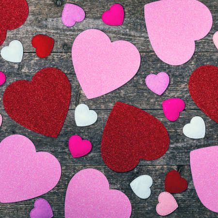 Valentines Day Background. Valentines Day Fabric Hearts Shaped on Wooden Background. Selective focus.の写真素材