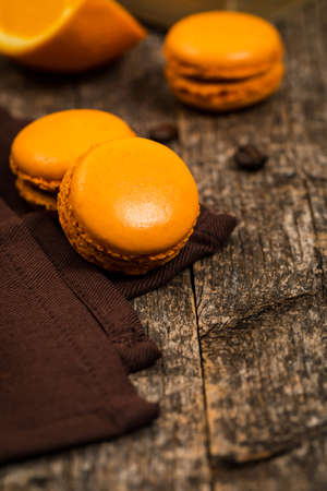 Orange French Macarons with Dark Chocolate and Coffee Filling. Selective focus.の写真素材