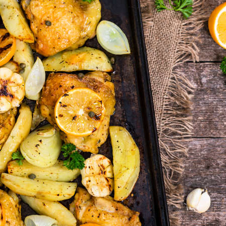 Chicken Thighs Roasted with Meyer Lemon and Potatoes. Selective focus.の写真素材