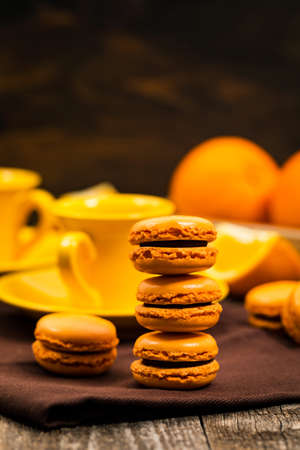 Orange French Macarons with Dark Chocolate and Coffee Filling. Selective focus.の写真素材