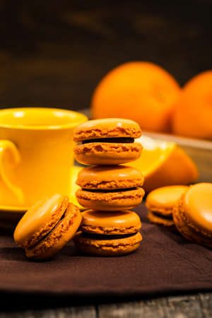 Orange French Macarons with Dark Chocolate and Coffee Filling. Selective focus.の写真素材