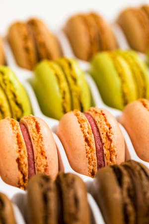 Colorful Macaroons Chocolate, Pistachio, Cherry, Orange, Vanilla Flavor Background. Selective focus.の写真素材