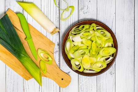Sliced Leek Green Onion on White Wooden Background. Selective focus.