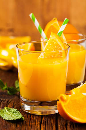 Orange Juice on Wooden Background. Selective focus.の写真素材